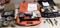 Overall view of two pneumatic nailers with cases, nails and accessories