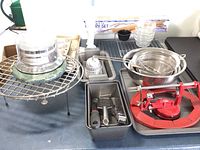 Photo showing various baking tools including cooling racks, mixing bowls, and apple corer.