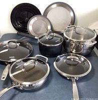 Overview photo showing all cookware items, their lids, and additional accessories.