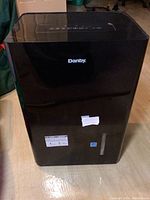 Front view of black Danby dehumidifier showing Danby logo, control panel on top and water reservoir level indicator.