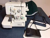 Machine on table with foot pedal and removable extension table