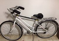 Side profile of the white Schwinn Wayfarer women's bike showing overall frame, handlebars, seat, and rear rack.