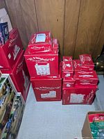 Multiple red boxes stacked featuring 'It's A Wonderful Life' and various village house names.