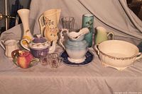 Group photo displaying various vintage ceramic and glass items including pitchers, vases, a teapot, and serving dish for overall context of the collection.