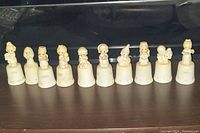 Front view of all 10 thimbles in a row showing figurines and year markings from 1987 to 1992.