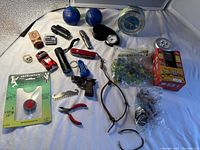 Full lot including toy car, cutters, lighters, clocks, marbles, stress balls, and tools