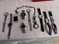 All ten watches laid out in single row on tablecloth