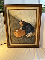Framed acrylic painting showing an elderly woman arranging flowers in a wooden crate, full view