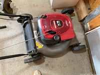Top view of red Craftsman lawn mower showing engine cover and deck.