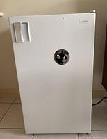 Front view of white Sanyo mini fridge with handle and sticker