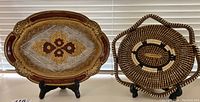 Photo showing both trays side by side, one hand painted Florentine tray and one hand woven tray