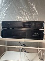 Front view of both CD player (top) and amplifier (bottom) on shelf