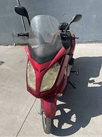 Front view showing red body, windshield, headlights