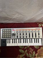 Full view of Korg microKONTROL Studio MIDI controller keyboard showing pads, keys, faders, knobs and buttons.
