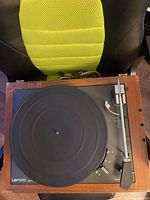 Top-down view of the entire turntable showing wood plinth, platter, tonearm and controls.