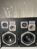Pair of Marantz HD440 speakers, front view showing woofer, midrange, and tweeter areas