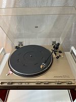 Full view of the Marantz TT4200 turntable with dust cover down showing black platter and tonearm with cartridge.