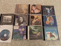 Photo of assortment of 11 music CDs including Celine Dion, Cat Stevens, Mormon Tabernacle Choir, Snow Boat soundtrack, and others.