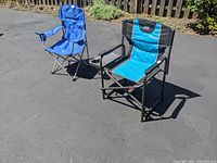 Two foldable chairs placed outdoors on pavement, showing overall design and colors.