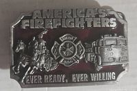 Front of the metal belt buckle with firefighter imagery and text.