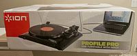 Box showing Ion Profile Pro USB Turntable with vinyl record and laptop connected by USB cable, with branding and product depiction.