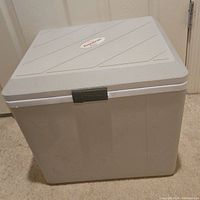 Closed view of rectangular grey cooler with lid and grey latch. Koolatron logo visible on lid.