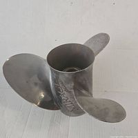 Front view of the stainless steel boat propeller showing three blades and central mounting hub.