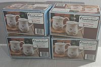 Four original packaging boxes each containing two stoneware mugs with floral patterns by Cumberland Heartstone.