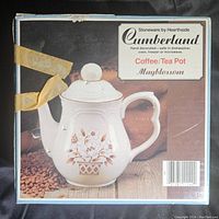 Photo showing the original box of the Cumberland Coffee/Tea Pot with Mayblossom pattern and minor wear to the box edges.