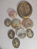 Nine assorted vintage miniature portraits, scenic decorative plates, and floral artwork items arranged on a white background.