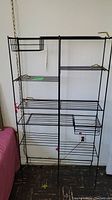 Full view of the retro style black wire bookshelf showing multiple shelves and compartments.