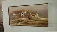 Full view of vintage oil painting on canvas framed in wood showing rural village scene with houses and trees.