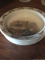 Photo of white ceramic oatmeal bowl with inside Bunnykins scene and brown bunny border around rim.