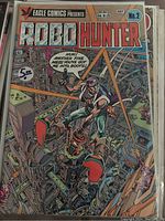 Front cover of Robo Hunter Comic #2 in plastic sleeve showing character with mechanical boots in a futuristic mechanical setting.