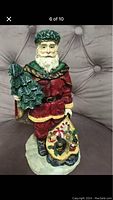 Front view of Santa Claus Christmas decoration with tree and festive miniature scene base