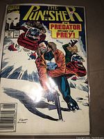 Image showing front cover of The Punisher comic book issue #49 with vibrant colors and action scene involving gunfight and Predators.