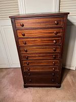 Front view showing all nine drawers and overall finish