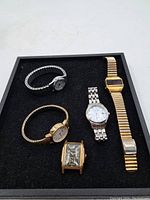 Lot of five vintage watches including a Tavannes, Timex Indiglo, and three other metal band watches in various styles.