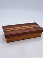 Closed handmade wooden box showing inlaid wood pattern on lid.