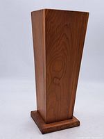 Front side view of the vintage tapered square wooden umbrella stand with visible wood grain and warm color tone.