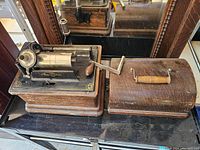 Front view of phonograph and wooden cover on display surface