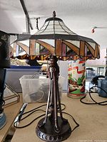 Front view of Tiffany-style lamp showing stained glass shade and metal base