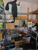 Full view of metal shelving unit with various boxes and items stored inside.