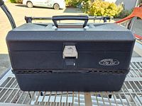 Closed Old Pal black plastic fishing tackle box with handle and metal clasp showing brand name plate.