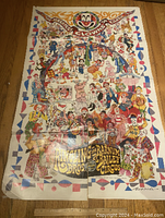 Full view of the circus poster showing colorful clowns and decorative border on a wooden floor.