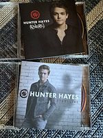 Front covers of two Hunter Hayes CD albums, Encore with a close-up portrait and Storyline with a casual standing pose.