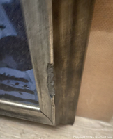 Close-up of frame damage showing a gouge on the side of the frame.