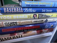 Photo showing stacked baseball books with visible titles