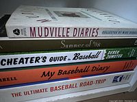 Stack of five paperback baseball books showing titles and condition.