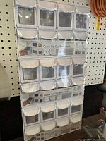 Set of three stacked quick tip-out storage bins still in original packaging, showing the full set and labels.